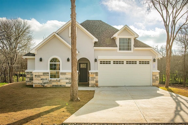 130 E Keomuku Ln, Bastrop, TX 78602 - view of front facade with stone siding, stucco siding, driveway, a shingled roof, and a garage