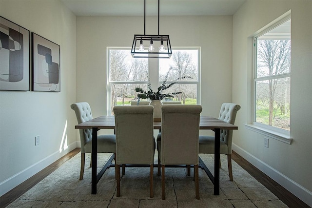 130 E Keomuku Ln, Bastrop, TX 78602 - dining area with wood finished floors, baseboards, and a chandelier