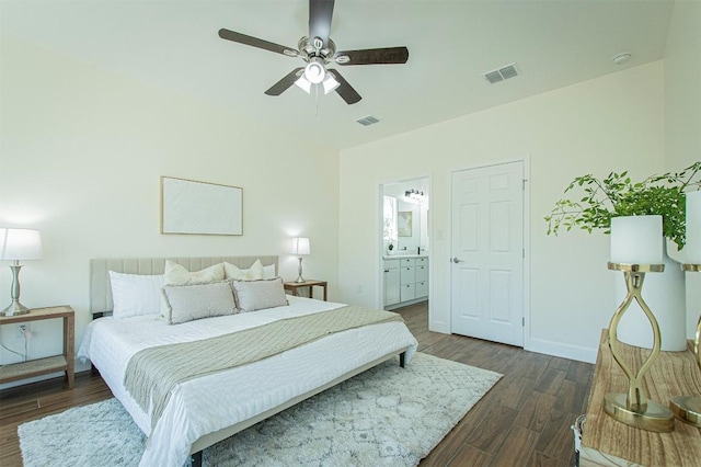 bedroom with dark wood-type flooring, ceiling fan, and ensuite bathroom