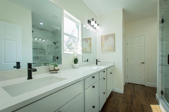 bathroom featuring walk in shower, wood-type flooring, and vanity