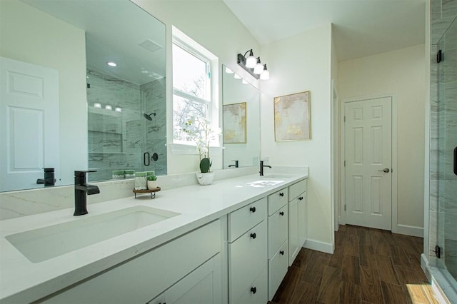 130 E Keomuku Ln, Bastrop, TX 78602 - full bath with double vanity, a shower stall, wood finished floors, and recessed lighting