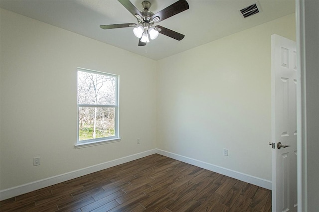 spare room with ceiling fan and dark hardwood / wood-style floors