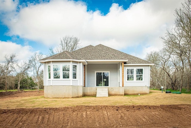 rear view of house featuring a yard