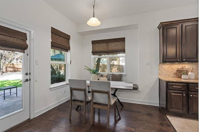 dining space featuring dark wood-type flooring and breakfast area