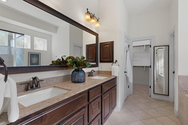 bathroom with tile patterned floors, vanity, and an enclosed shower