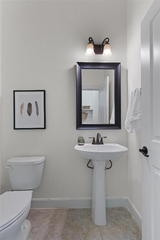 bathroom with tile patterned flooring and toilet