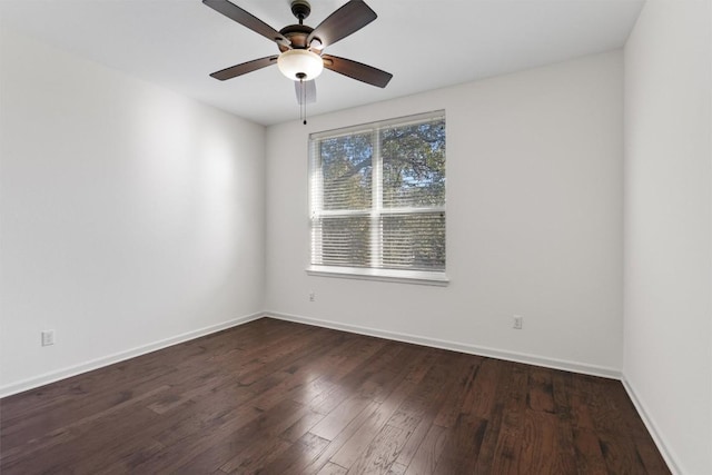 empty room featuring dark hardwood / wood-style flooring and ceiling fan