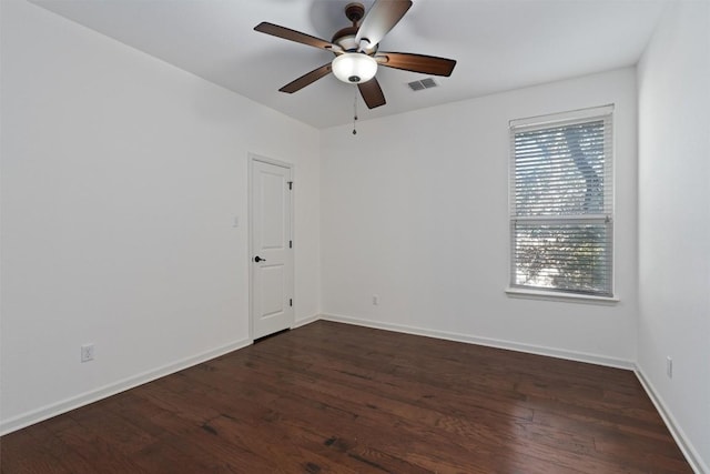 spare room featuring dark wood-type flooring and ceiling fan