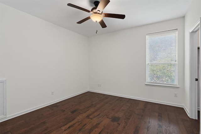 spare room featuring dark wood-type flooring and ceiling fan