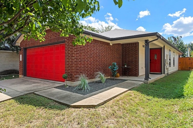 ranch-style house featuring a garage and a front lawn