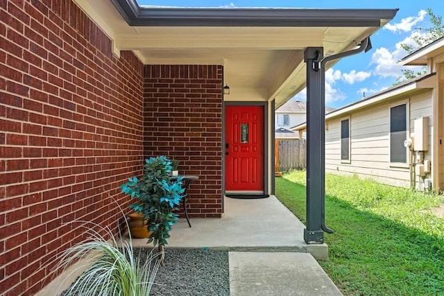 entrance to property with a lawn