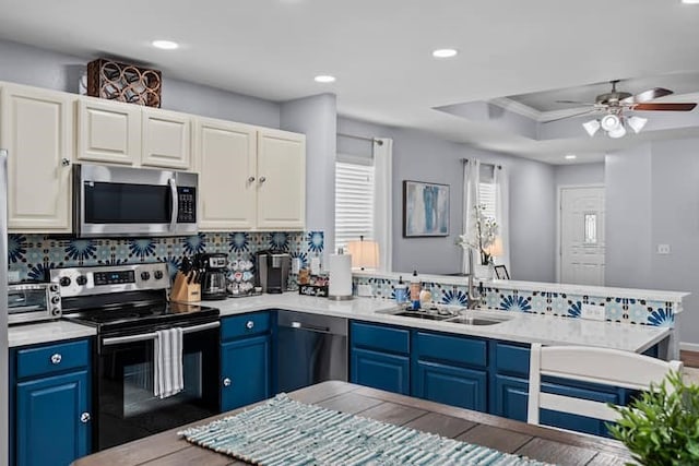 kitchen with blue cabinets, sink, and appliances with stainless steel finishes