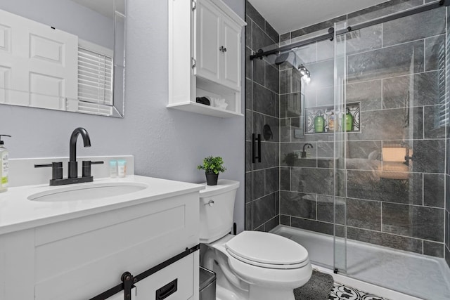 bathroom with vanity, an enclosed shower, and toilet