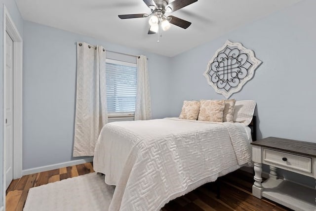 bedroom with dark hardwood / wood-style floors and ceiling fan