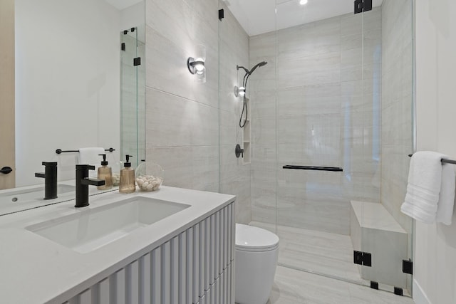 bathroom with a shower with door, vanity, and toilet