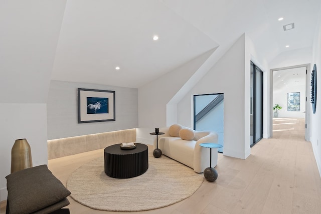 sitting room featuring vaulted ceiling and light hardwood / wood-style floors