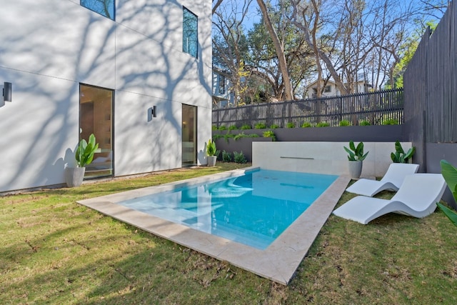 view of pool with a yard and a patio area