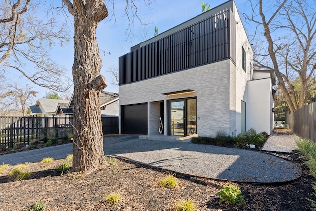 rear view of property featuring a garage