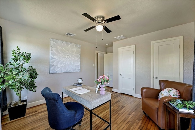 office area featuring wood-type flooring, a textured ceiling, and ceiling fan