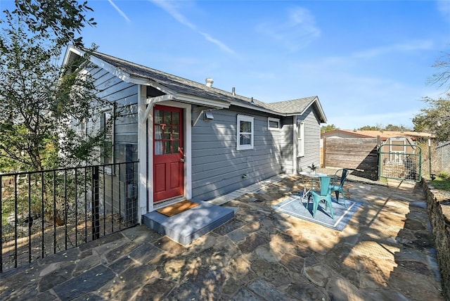 2201 Indian Creek Rd, Austin, TX 78734 - rear view of house featuring a patio and a shingled roof