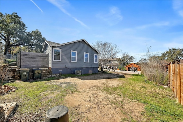 view of side of home with a lawn