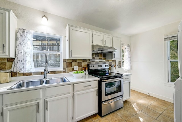 kitchen featuring stainless steel range with electric stovetop, sink, backsplash, and white cabinets