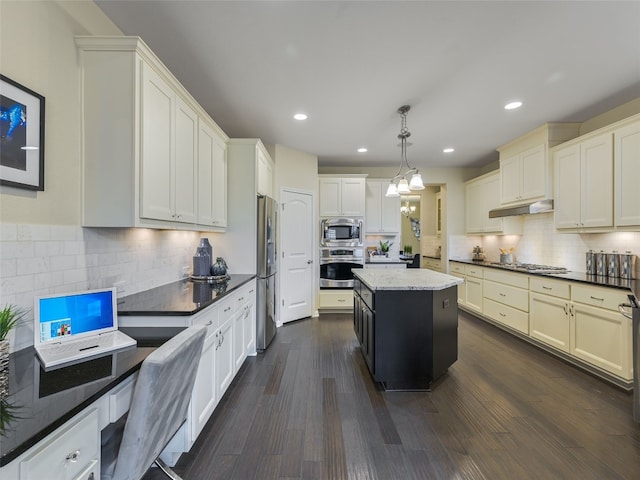 kitchen with a center island, hanging light fixtures, dark stone countertops, dark hardwood / wood-style flooring, and stainless steel appliances