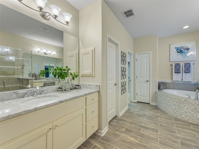 bathroom featuring vanity and separate shower and tub