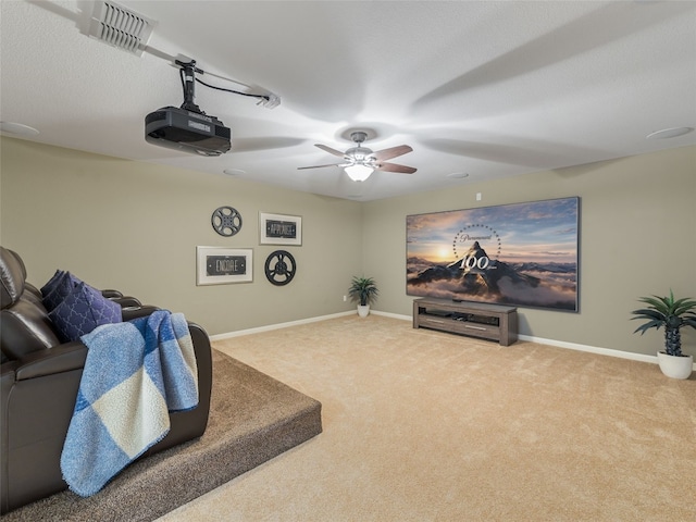 carpeted cinema room with ceiling fan and a textured ceiling