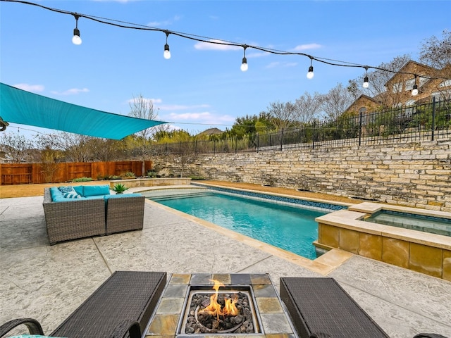 view of swimming pool featuring an outdoor living space with a fire pit, a patio, and an in ground hot tub