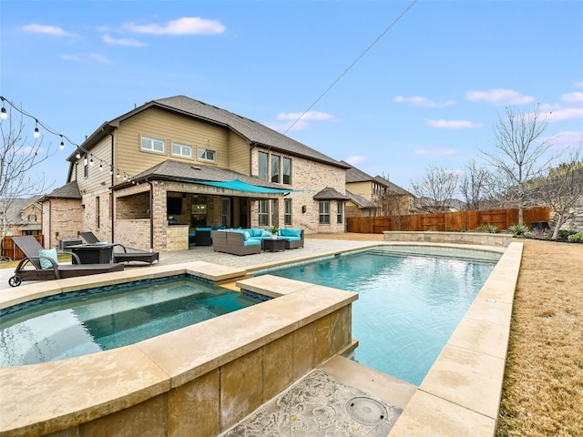 view of pool with an outdoor living space, a patio area, and an in ground hot tub