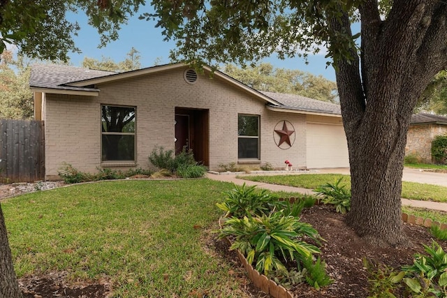 ranch-style house featuring a garage and a front lawn