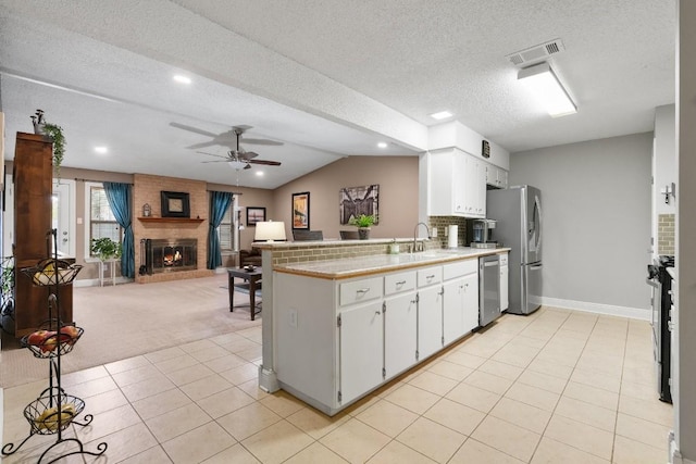 kitchen with white cabinetry, stainless steel appliances, light tile patterned flooring, and sink