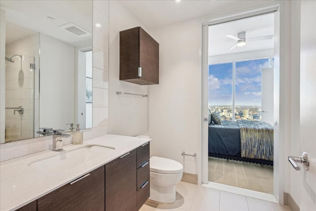 bathroom featuring vanity, toilet, an enclosed shower, and tile patterned flooring