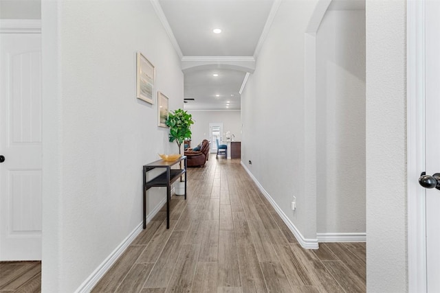 hallway featuring crown molding and hardwood / wood-style flooring