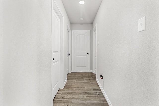 hallway with light hardwood / wood-style floors