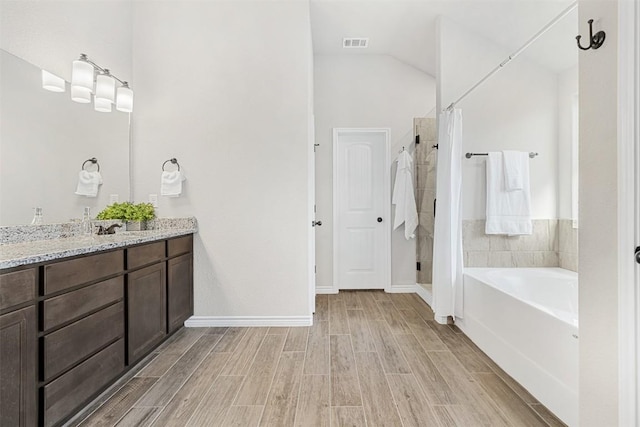 bathroom featuring vanity and separate shower and tub