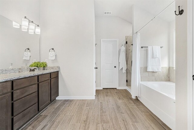 2651 Cowgirl Trl, Belton, TX 76513 - full bath with wood finished floors, vanity, a stall shower, and vaulted ceiling