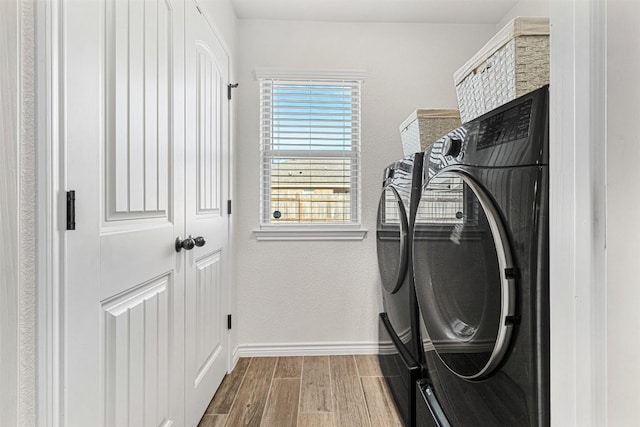 2651 Cowgirl Trl, Belton, TX 76513 - washroom featuring washing machine and dryer, wood finished floors, and baseboards