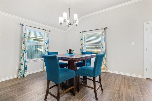 dining area featuring crown molding, lofted ceiling, wood-type flooring, and a notable chandelier