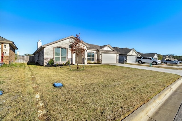 single story home with a garage and a front lawn