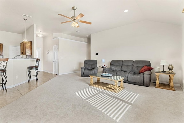 living room featuring vaulted ceiling, light colored carpet, and ceiling fan