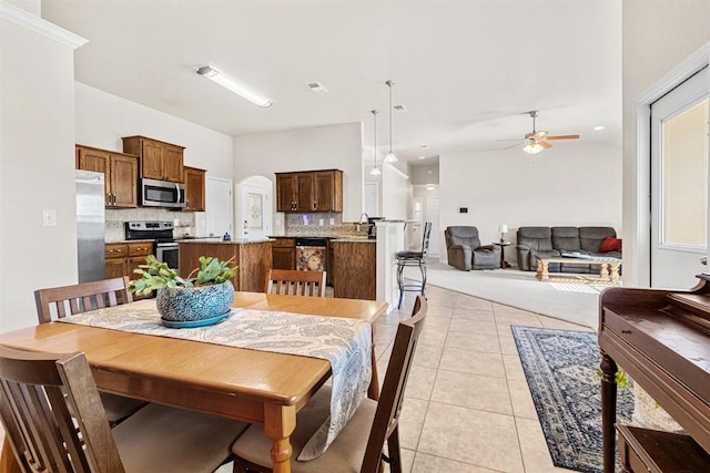 tiled dining room with ceiling fan