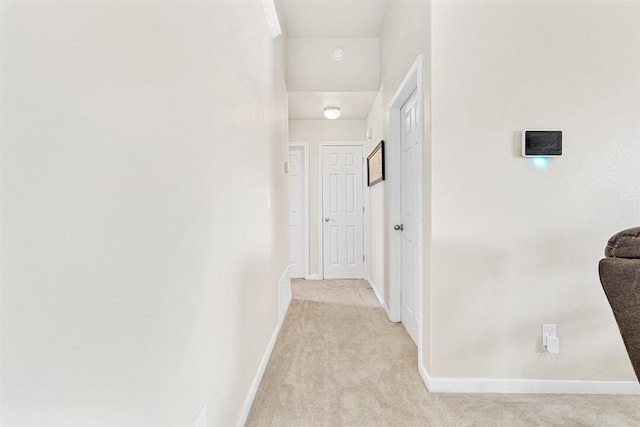 corridor featuring light colored carpet