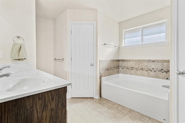 bathroom featuring tile patterned floors, a bath, and vanity