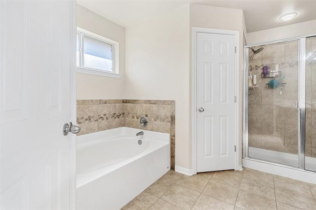 bathroom with tile patterned flooring and independent shower and bath