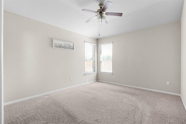 unfurnished room with ceiling fan and carpet flooring