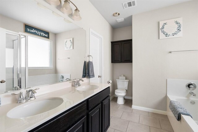 bathroom with vanity, a bath, tile patterned floors, and toilet