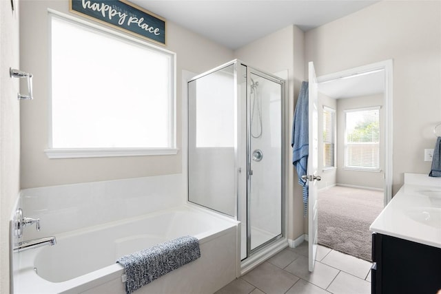 bathroom with tile patterned floors, vanity, and separate shower and tub