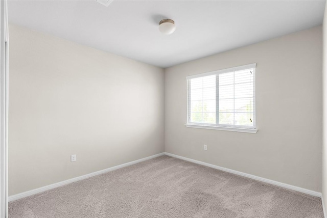 unfurnished room with light colored carpet